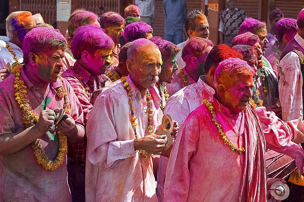 Garlanded men with cymbals in religious procession going to the temple at Holi festival, Jaipur, Rajasthan, India, Asia