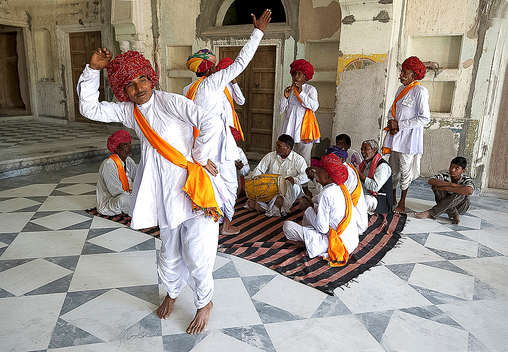 Troup of Rajasthani dancers and musicians performing traditional dance in 18th century Diggi palace Durbar Hall, Rajasthan, India, Asia