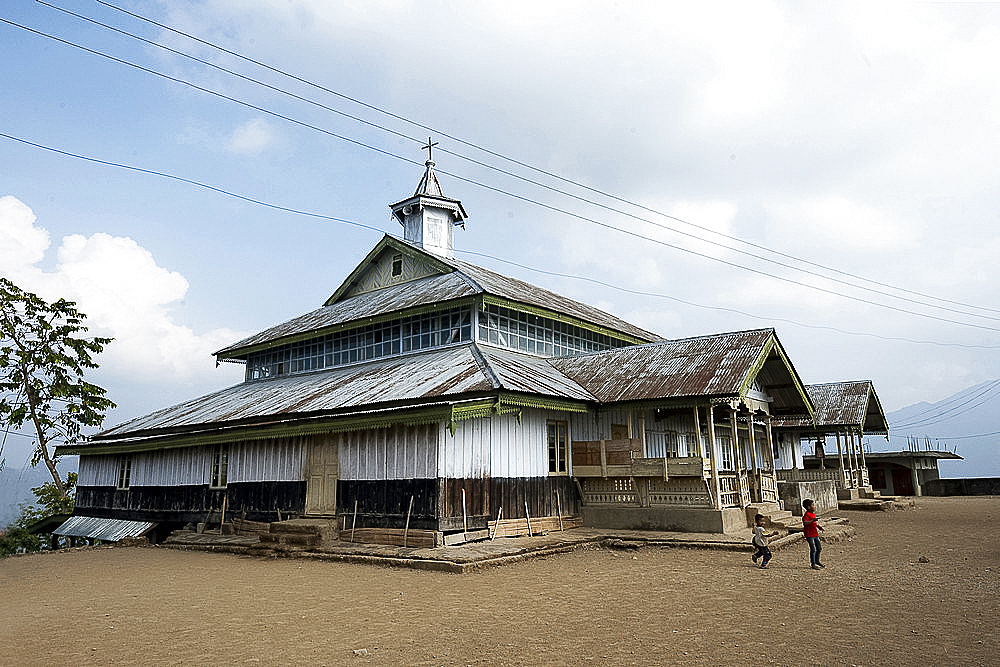 Large, wooden built Baptist church at the top of Naga tribal village, community converted from Animism to Christianity, Nagaland, India, Asia