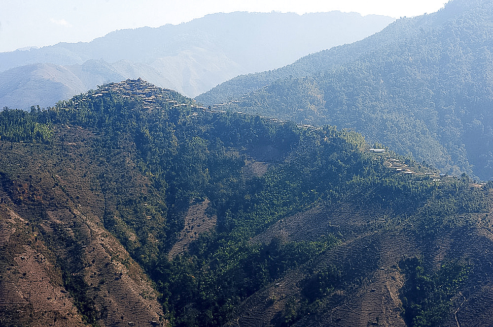 One of the countless hilltop Naga villages in the verdant Naga hills, Baptist church at its peak, Nagaland, India, Asia