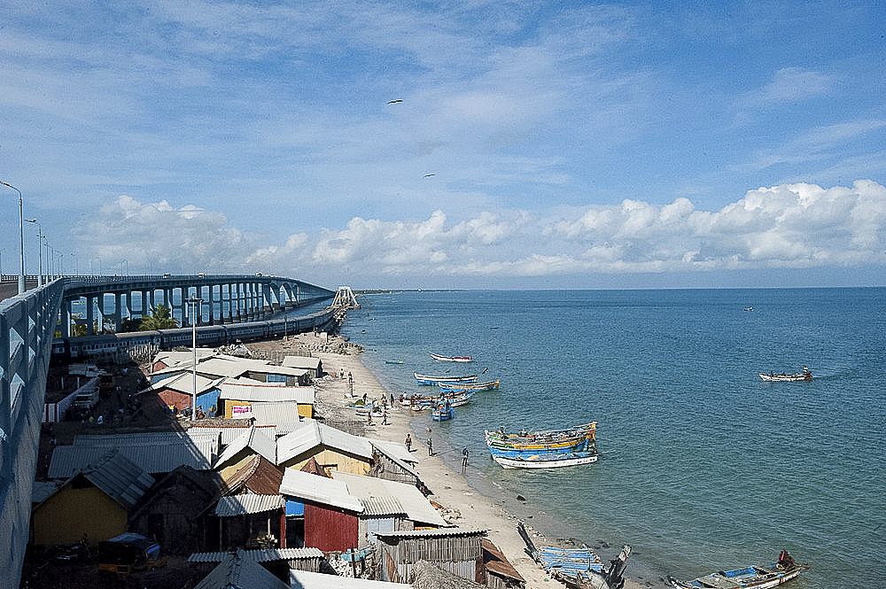 Fisherman community under Pamban Bridge with colourful fishing boats, Pamban Straits, Rameshwaram, Tamil Nadu, India, Asia