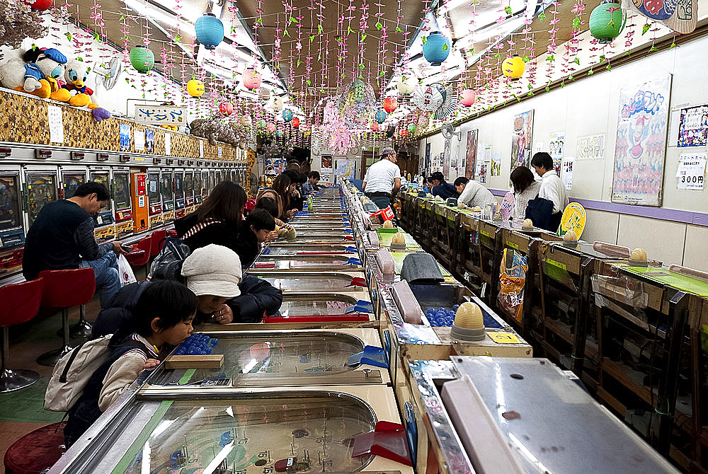 A pachinko parlor with pacuislos (slot machines) on the walls, Machiye, Tokyo, Japan, Asia