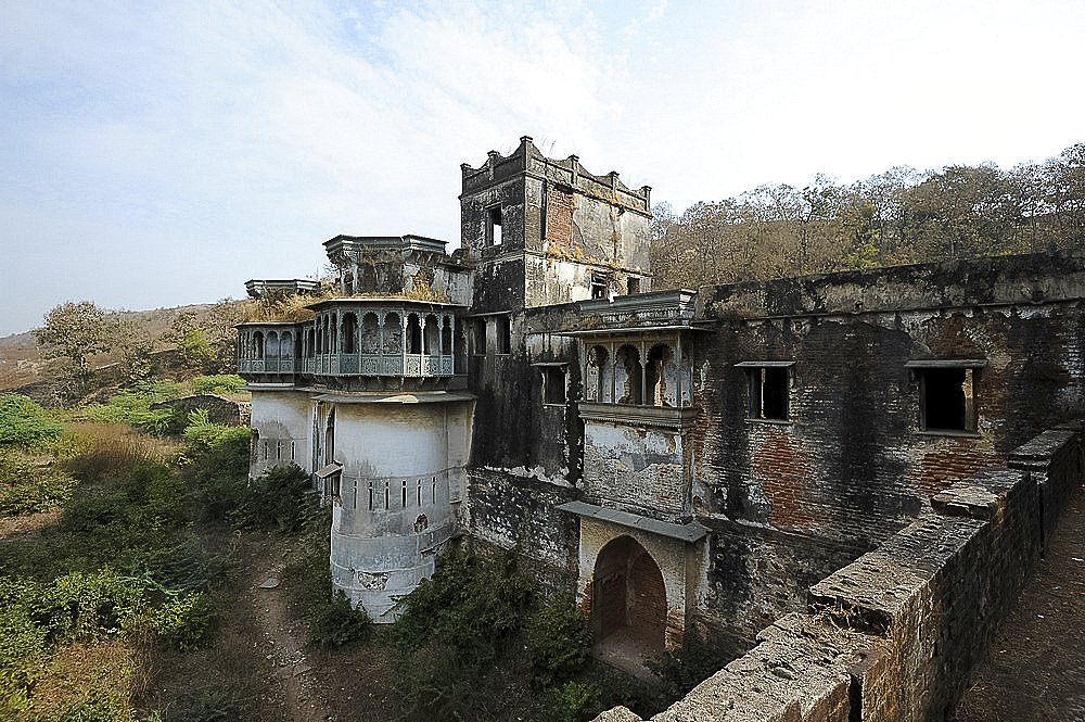 Ruins of the largely derelict but beautiful ornate 19th century royal Raj Mahal, high in the hills of Santrampur, Gujarat, India, Asia