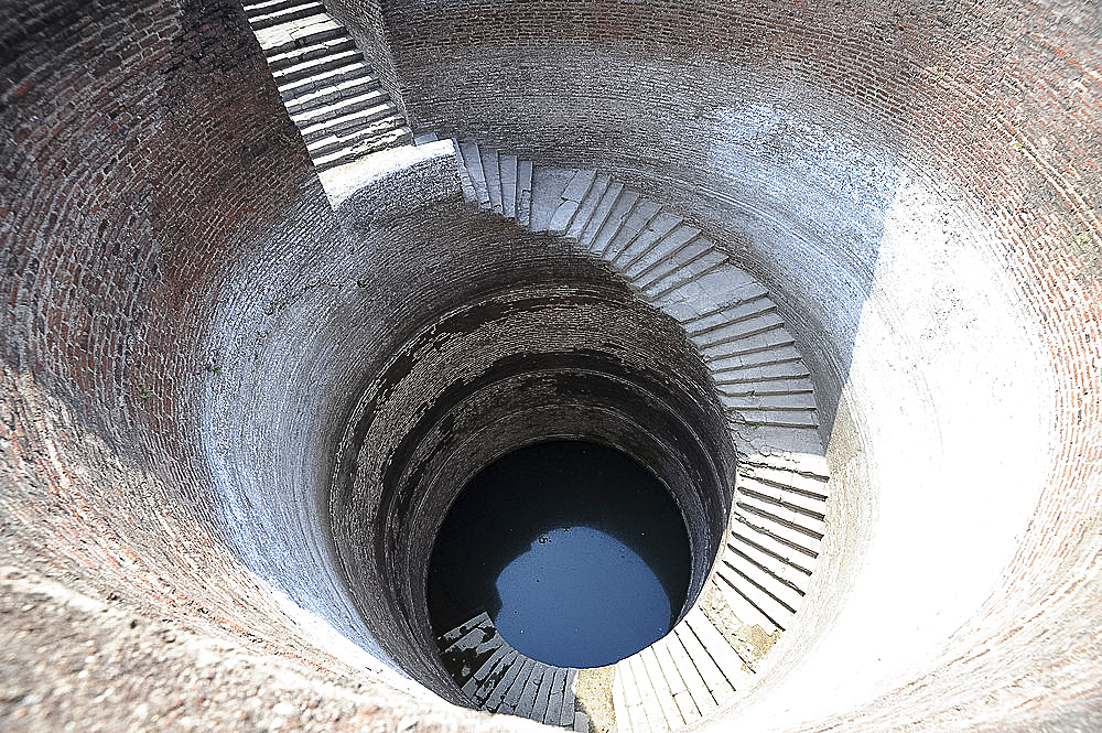 Helical stepwell, 16th century well with a 1.2m-wide staircase spiralling down the wall of the well shaft, Champaner, Gujarat, India, Asia