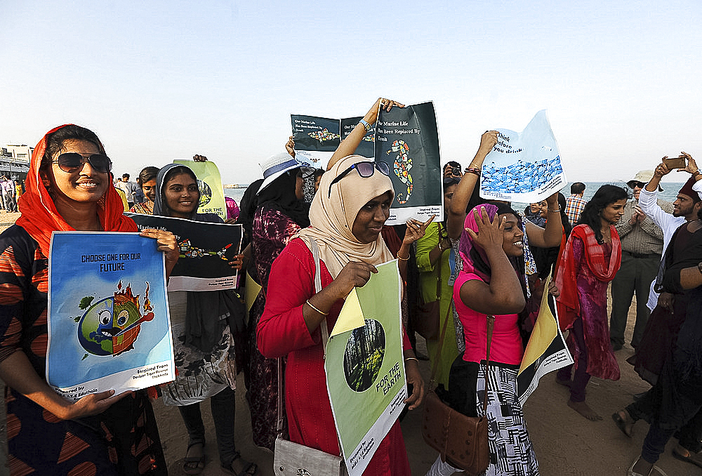 Women holding posters protesting against plastic pollution on the beach promenade in Pondicherry, Tamil Nadu, India, Asia