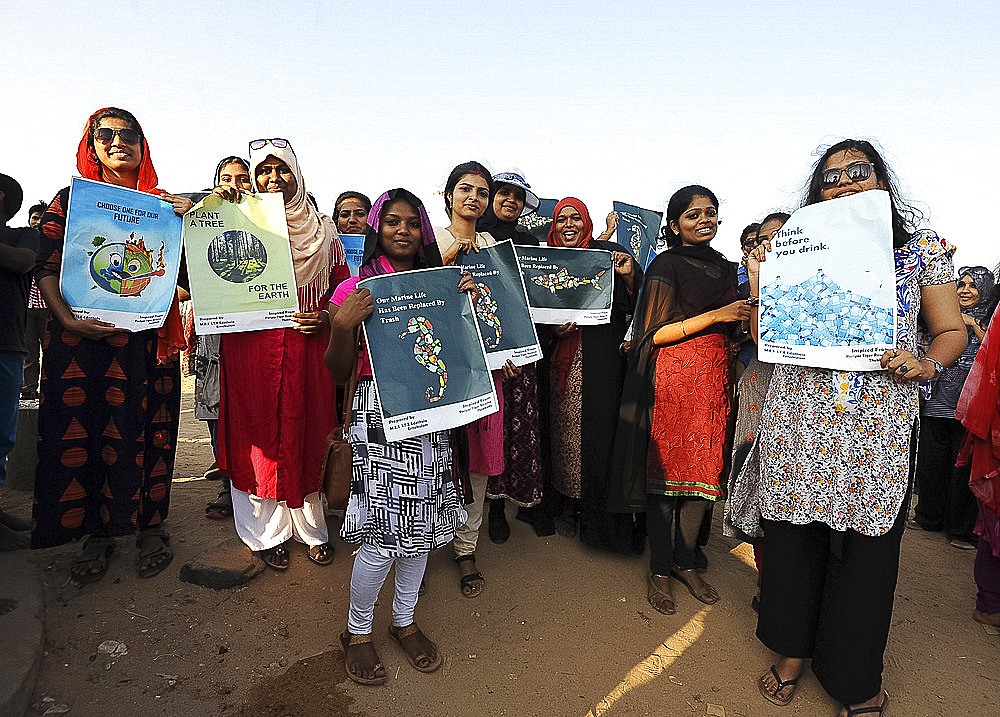 Women holding posters protesting against plastic pollution on the beach promenade in Pondicherry, Tamil Nadu, India, Asia