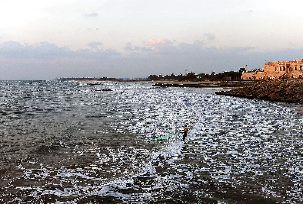 Fisherman fishing with a net in the early morning in the waters of the Bay of Bengal, Tranquebar, Tamil Nadu, India, Asia