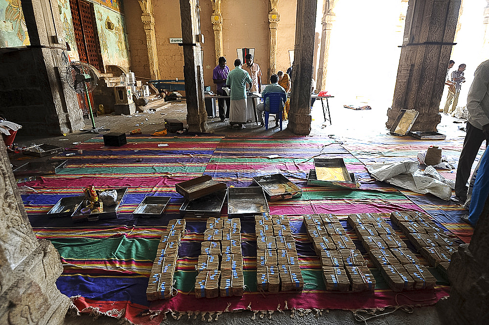 Donations of rupees being sorted, counted and bundled inside the 11th century Brihadisvara Cholan temple, Thanjavur, Tamil Nadu, India, Asia