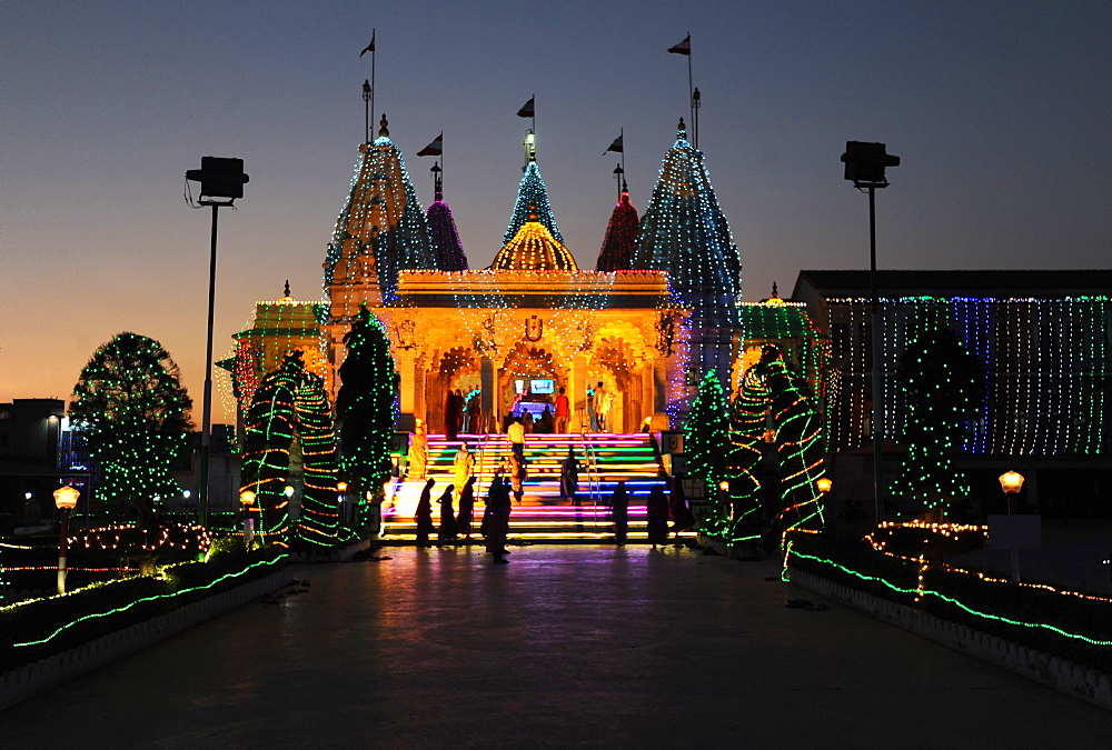 Diwali festival lights illuminating the entrance to the white marble Swaminarayan Temple, Mandvi, Gujarat, India, Asia