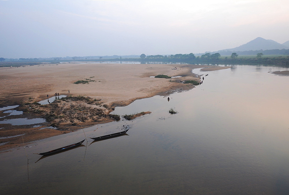 Morning light over river boats moored on the banks of the Mahanadi river, Cuttack district, Odisha, India, Asia