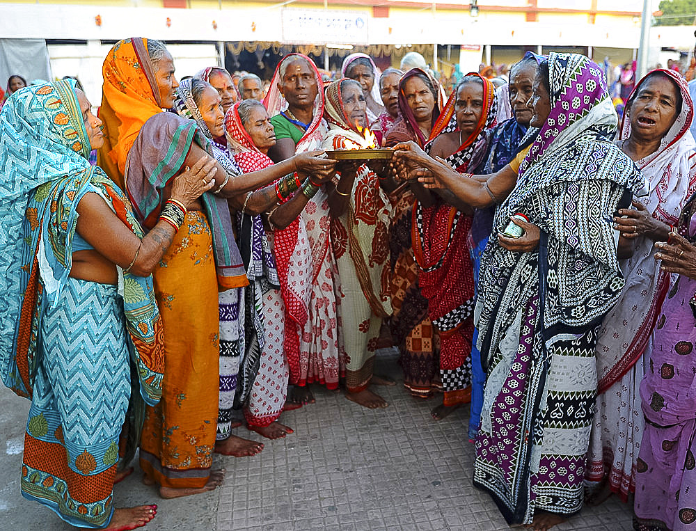 Widows gathered to celebrate Kartika Brata month long festival by fasting together and burning puja lamps, Puri, Odisha, India, Asia