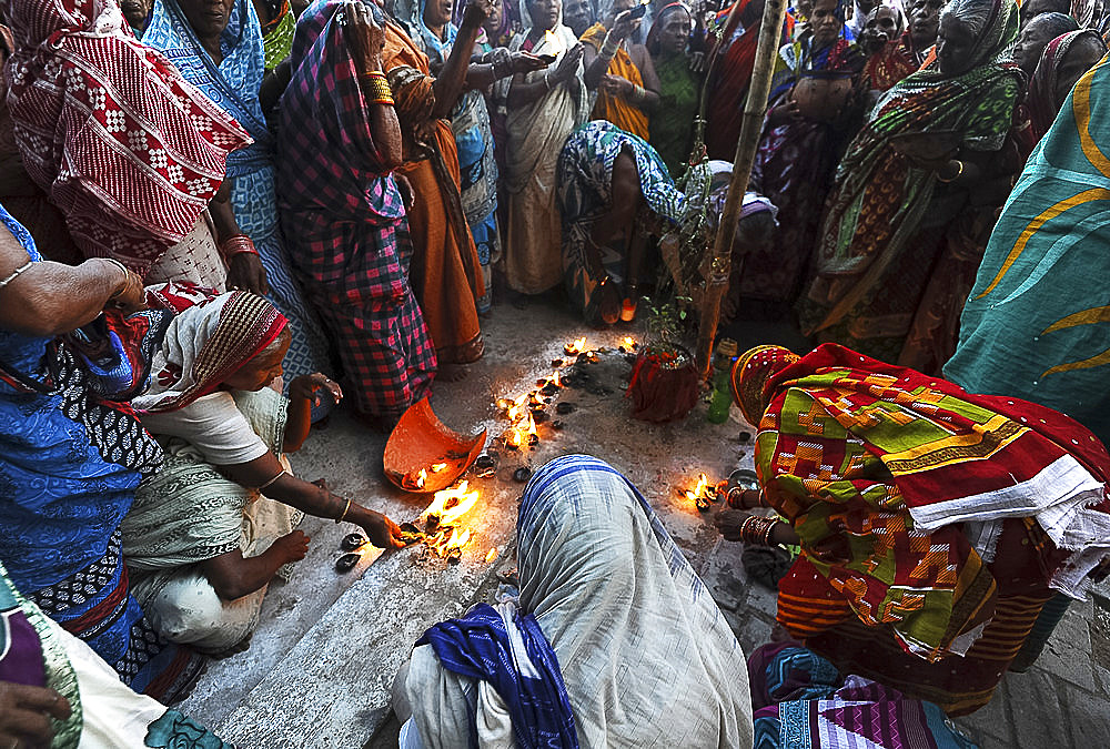 Widows gathered to celebrate Kartika Brata month long festival by fasting together and burning puja lamps, Puri, Odisha, India, Asia