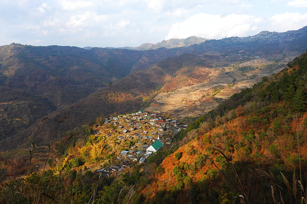 View across Naga hills over small Naga village, terraced ricefields and farmland, Nagaland, India, Asia