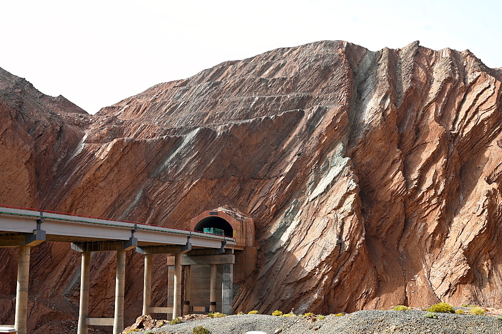 Recent Silk Road construction through solid rock in the Taklamakan Desert near Kuche, Xinjiang, China, Asia