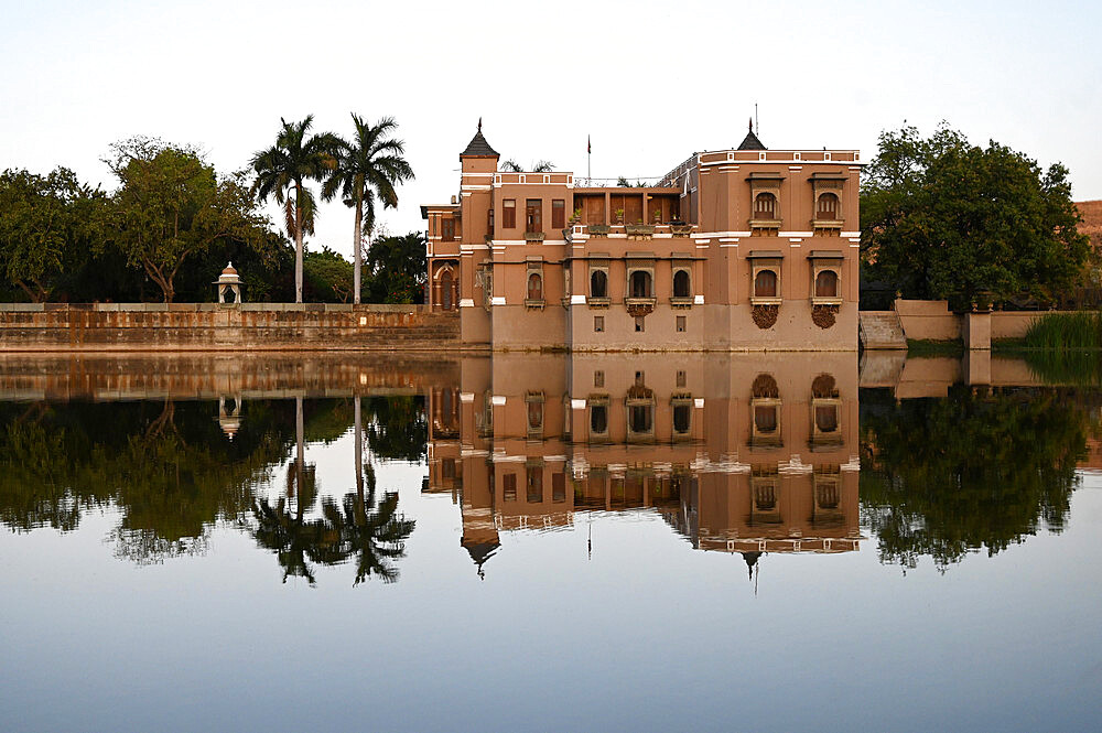 Sri Joravar Vilas reflected in the still waters of the lake, swallows nests made beneath its windows, Santrampur, Gujarat, India, Asia