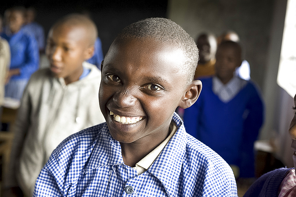 Smiling schoolboy in classroom, Karunga Primary School, Rift Valley, Kenya, East Africa, Africa