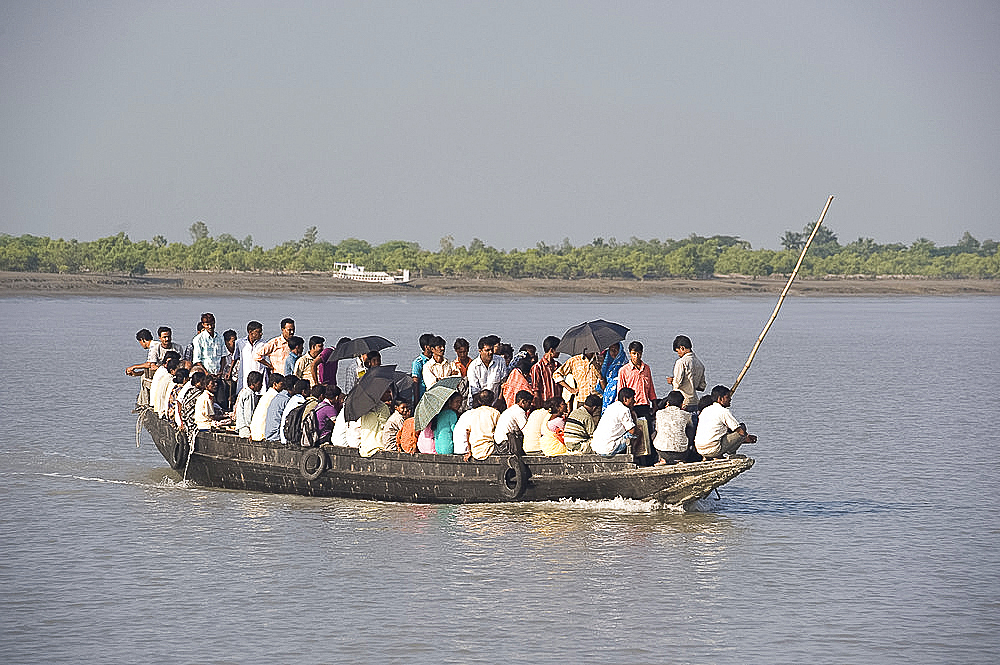 Small wooden ferry boat crowded with people, Gothakali Port, Sunderbans, West Bengal, India, Asia