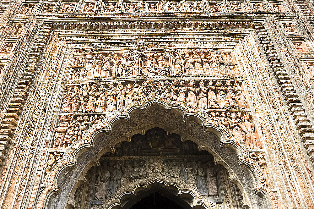 Ornate terracotta carvings of Hindu gods over the arched entrance to the Pratapeswar Temple (Pratapeshvara Mandir), a 19th century Rekha Deul, Kalna, West Bengal, India, Asia