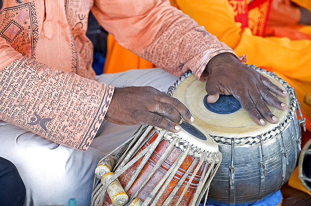 Hindu musician playing the tabla (drums) with typical black spot made from a mixture of gum, soot and iron filings, West Bengal, India, Asia