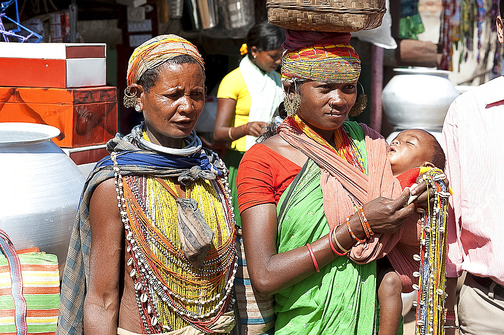 Two Bonda tribeswoman and baby in traditional bead costume and necklaces wearing contemporary costume, beaded caps and earrings, Rayagader, Orissa, India, Asia