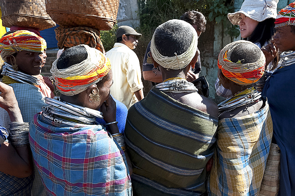 Bonda tribeswomen wearing traditional beaded caps and metal necklaces, selling beads to tourists at weekly market, Rayagader, Orissa, India, Asia