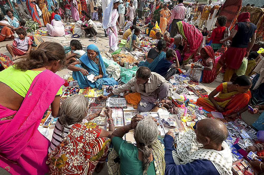 Village women surrounding a stall selling hair products at the Sonepur Cattle fair, Bihar, India, Asia