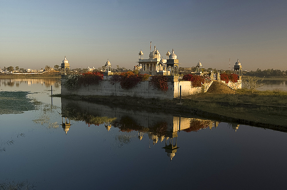 Reflection of temple in lake at dawn, Dungarpur, Rajasthan, India, Asia