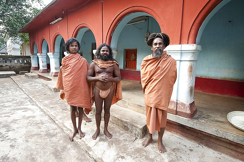 Barefoot Joranda monks wearing orange cloths in a monastery building, Joranda, Orissa, India, Asia