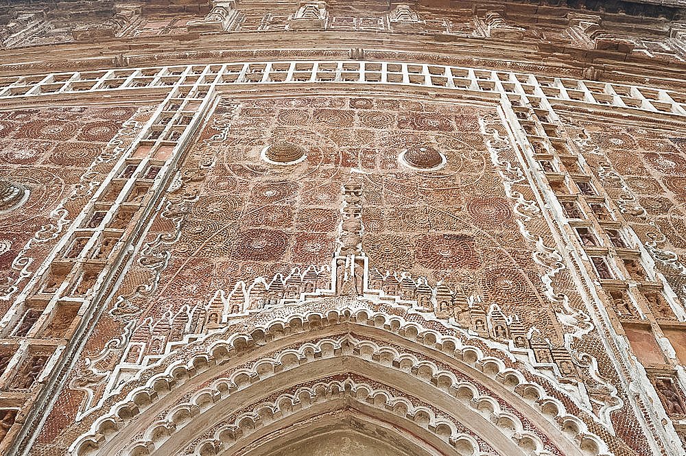 Carved terracotta work above arched doorway in the Lalji Mandir, one of the terracotta temples at Kalna, West Bengal, India, Asia