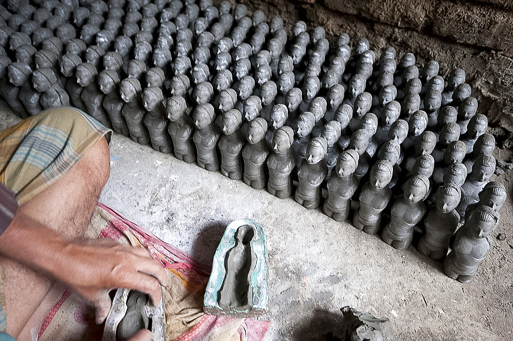 Models being made from clay from the River Hugli in moulds, to be painted for puja ceremonies, Kumartuli district, Kolkata, West Bengal, India, Asia