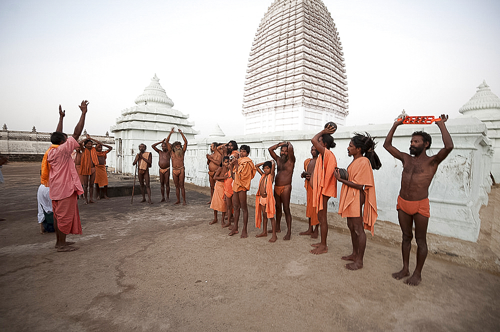 Joranda monks chanting in ritual prayer at dusk at temple containing dhuni, eternal butter lamp, Joranda, Dhenkanal, Orissa, India, Asia