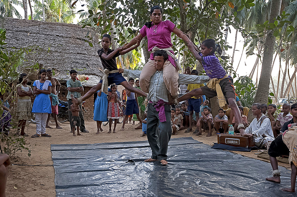 Four dancers whirling round as part of a traditional Gotipua (single boy) temple dance performance, Ballia, rural Orissa, India, Asia