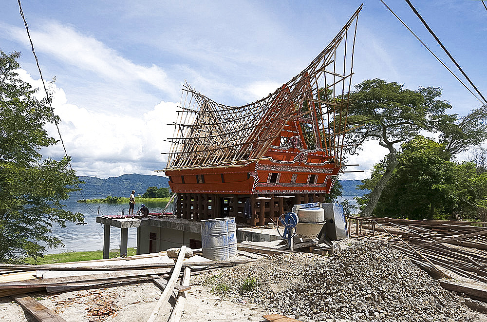 Construction of traditional style Batak house with bamboo scaffolding, beside the volcanic Lake Toba, Samosir Island, Sumatra, Indonesia, Southeast Asia, Asia