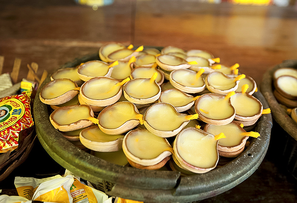 Oil and cotton wick diya (puja lamps) in terracotta dishes, at the Bhubaneshwari temple, Nilachal Hill, Guwahati, Assam, India, Asia