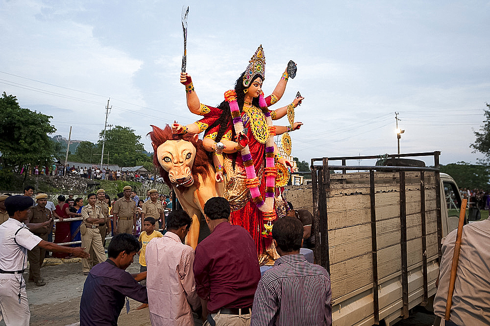 Durga puja deity, made from river mud and decorated, being taken to the Brahmaputra riverbank for Durga puja immersion ceremony, Guwahati, Assam, India, Asia