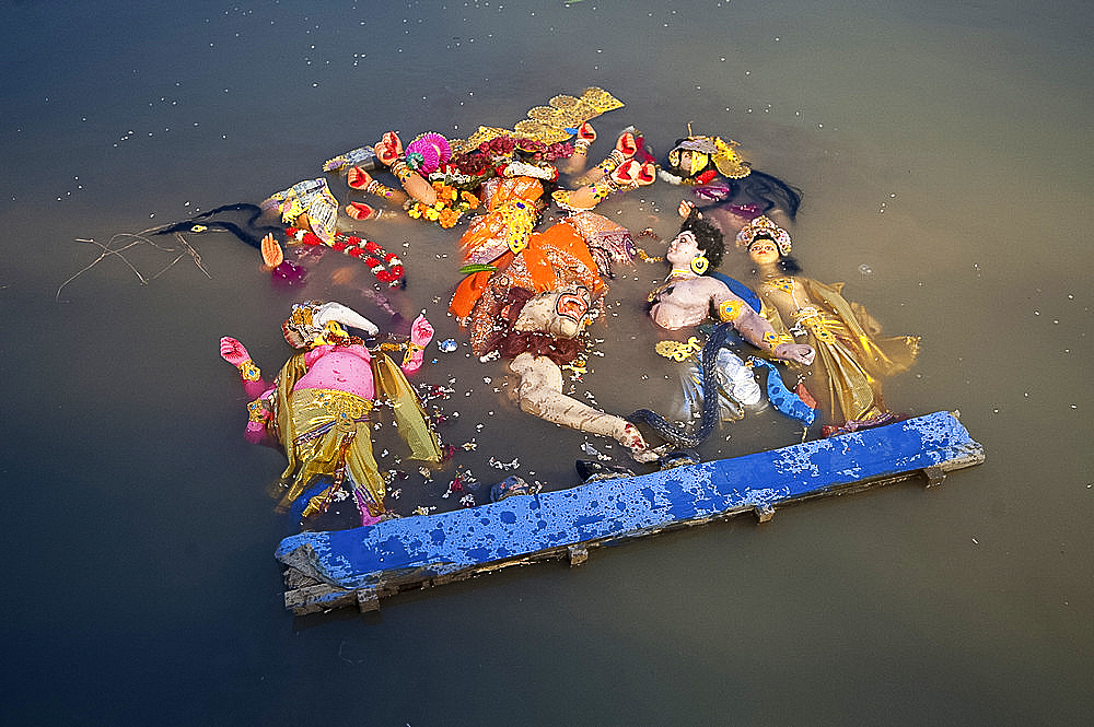 Durga puja deity, made from river mud and decorated, in the Brahmaputra River at Hindu Durga puja immersion ceremony, Guwahati, Assam, India, Asia