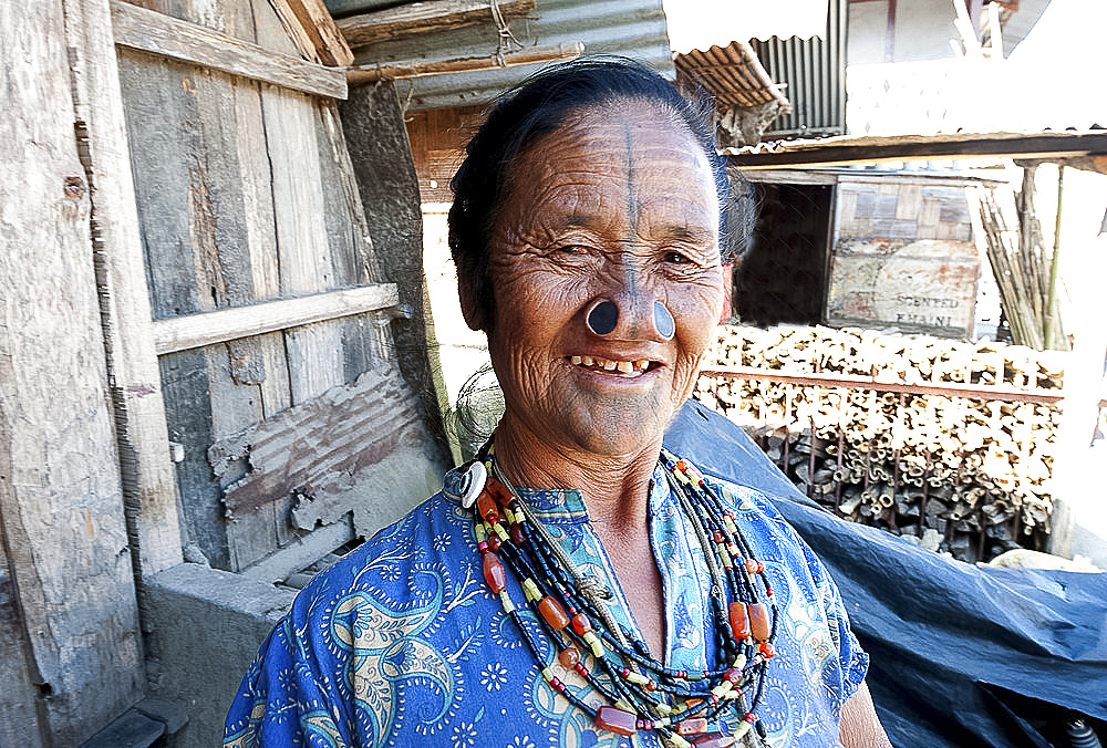 Apatani tribal woman with traditional yaping hullo (nose plugs) and facial tiipe (tatooing) and a crucifix, Arunachal Pradesh, India, Asia