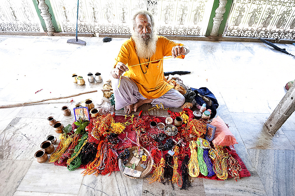 Hindu pundit selling rolimoli (puja wrist threads) in the Sivadol temple, built in 1734, Sivasagar, Assam, India, Asia