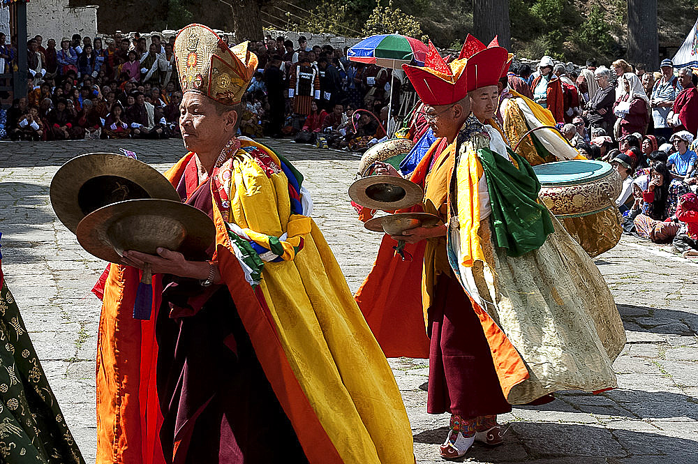 Monk musicians in ceremonial costume playing Bhutanese cymbals and drums at Paro Tsechu (annual monastery festival), Paro, Bhutan, Asia