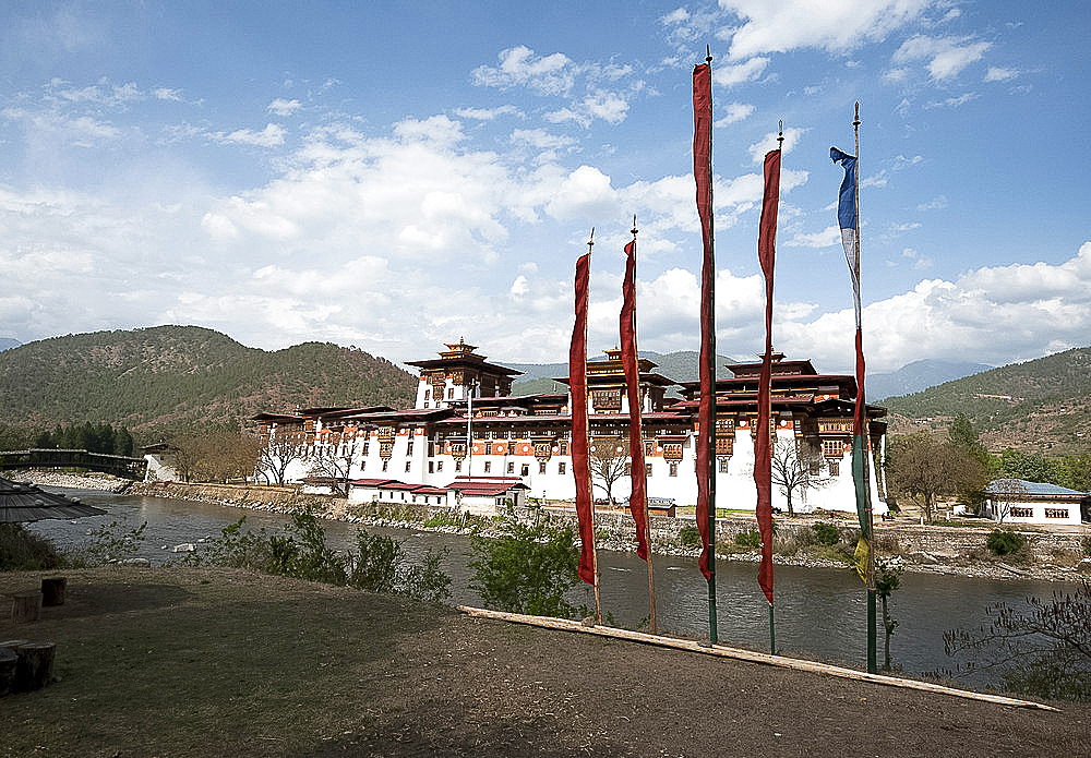 Prayer flags by Punakha dzong (monastery), at the confluence of the Pho chu (Father) and Mo Chu (Mother) rivers, Punakha, Bhutan, Asia