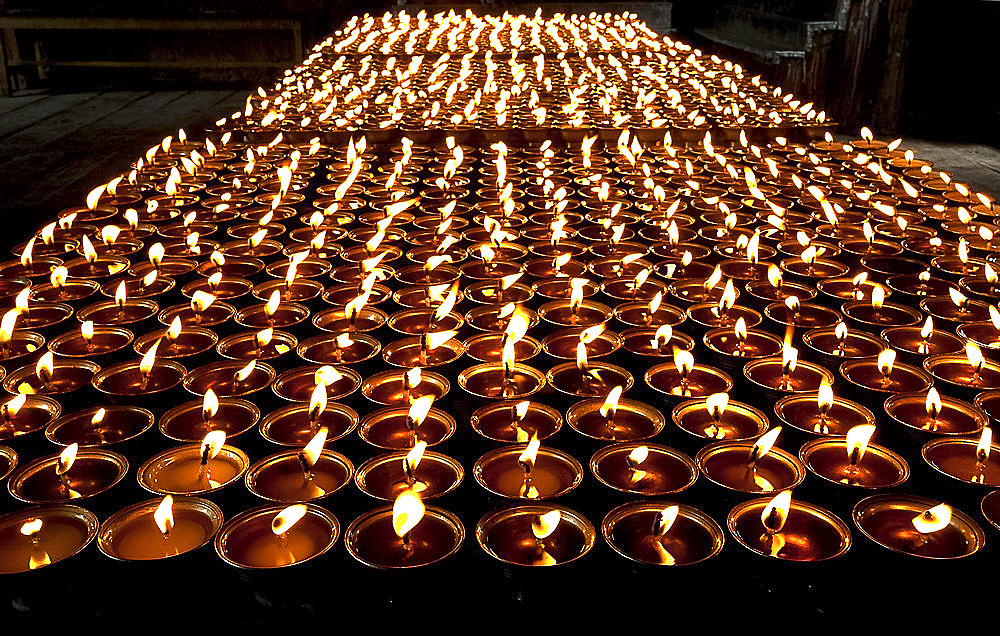 Butter lamps lit in Mongar Dzong (monastery), built in the 1930s, one of Bhutan's newest dzongs, built without plans or nails, Bhutan, Asia