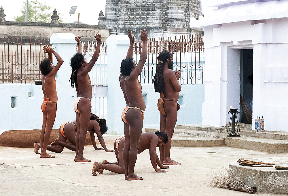 Joranda monks in saffron loincloths performing daily sunset devotional prayer ceremony at Joranda monastery, Odisha, India, Asia