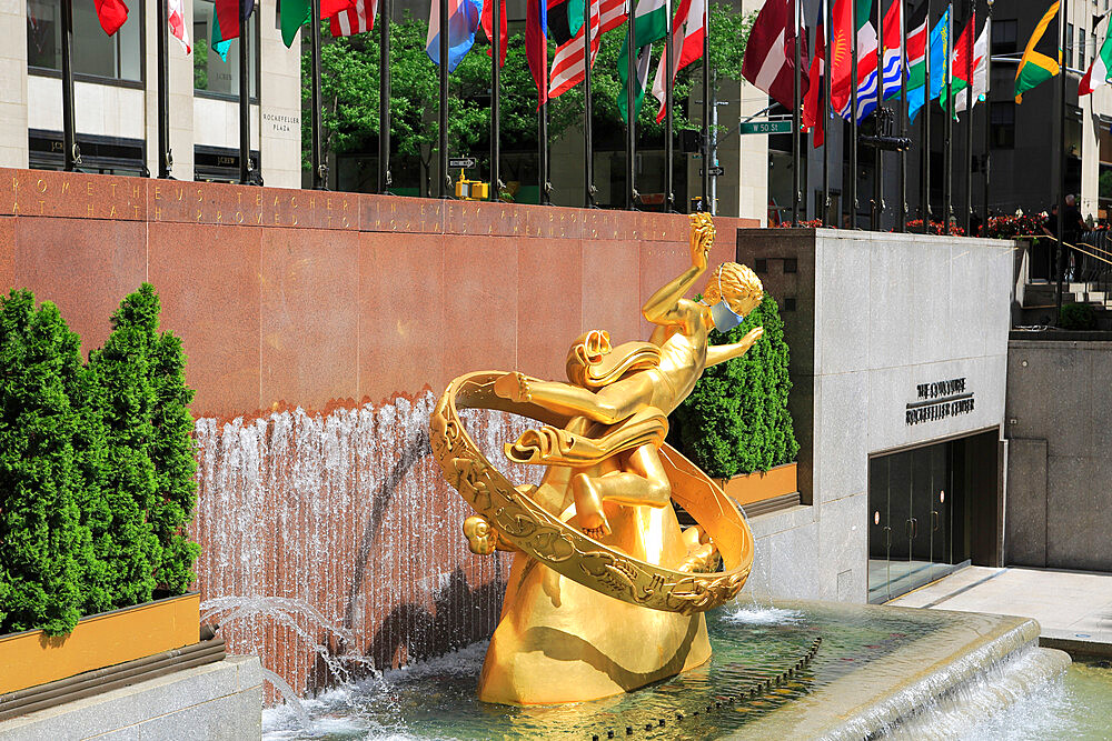 Prometheus Statue wearing mask during Coronavirus, Covid-19 Pandemic, Rockefeller Center, Plaza, Manhattan, New York City, United States of America, North America