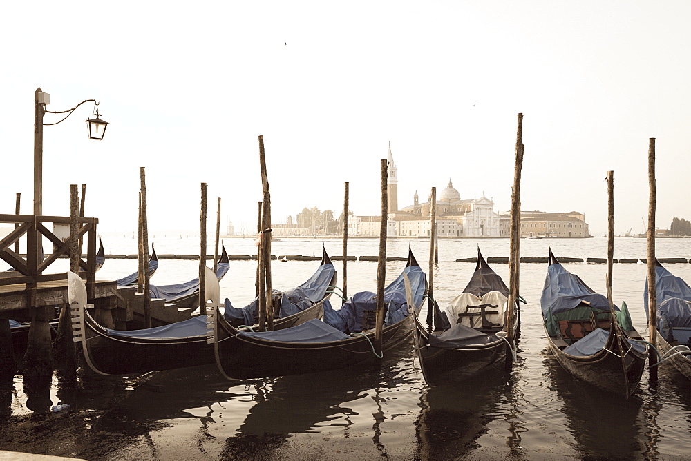 Gondolas moored on the Lagoon, San Giorgio Maggiore beyond, Riva degli Schiavoni, Venice, UNESCO World Heritage Site, Veneto, Italy, Europe