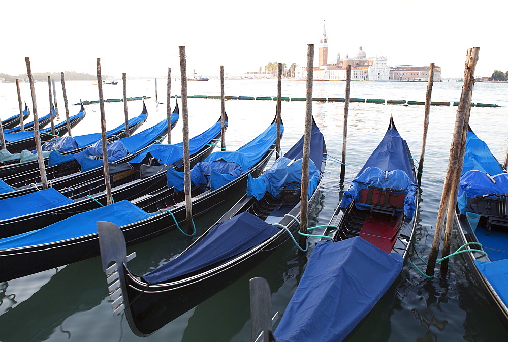 Gondolas moored on the Lagoon, San Giorgio Maggiore beyond, Riva degli Schiavoni, Venice, UNESCO World Heritage Site, Veneto, Italy, Europe