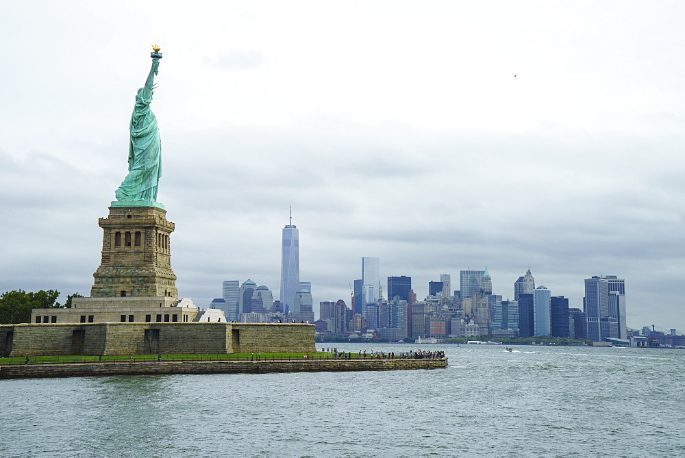 Statue of Liberty with the Lower Manhattan skyline and One World Trade Center beyond, New York City, New York, United States of America, North America