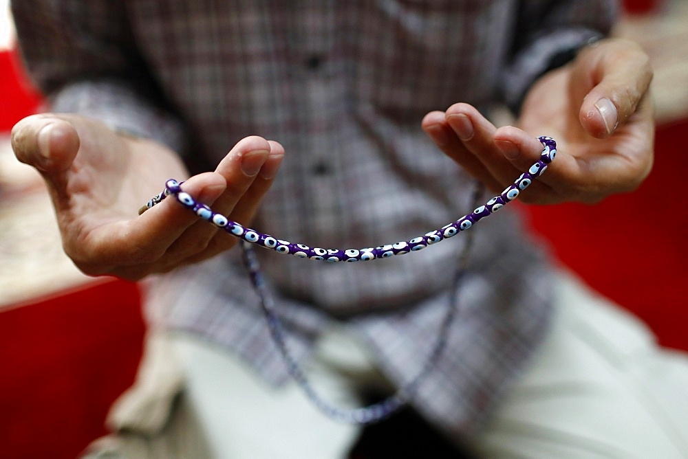 Close-up of Muslim man praying with prayer beads (Masbahah), Hanoi, Vietnam, Indochina, Southeast Asia, AsiaClose-up.