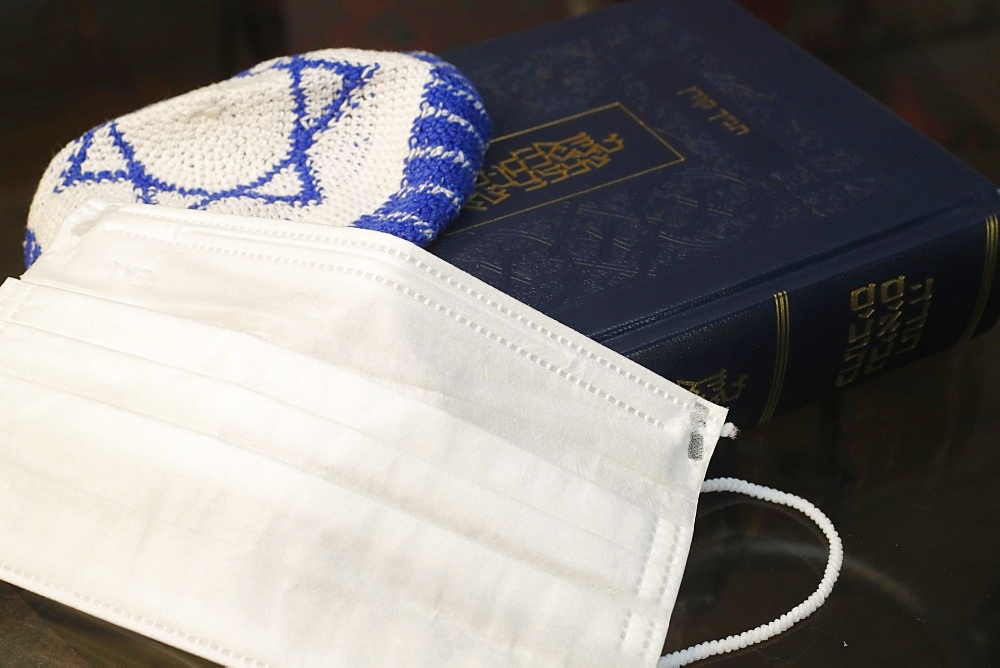 Religion and coronavirus (COVID-19), Torah, kippah and disposable surgical mask, Haute-Savoie, France, Europe