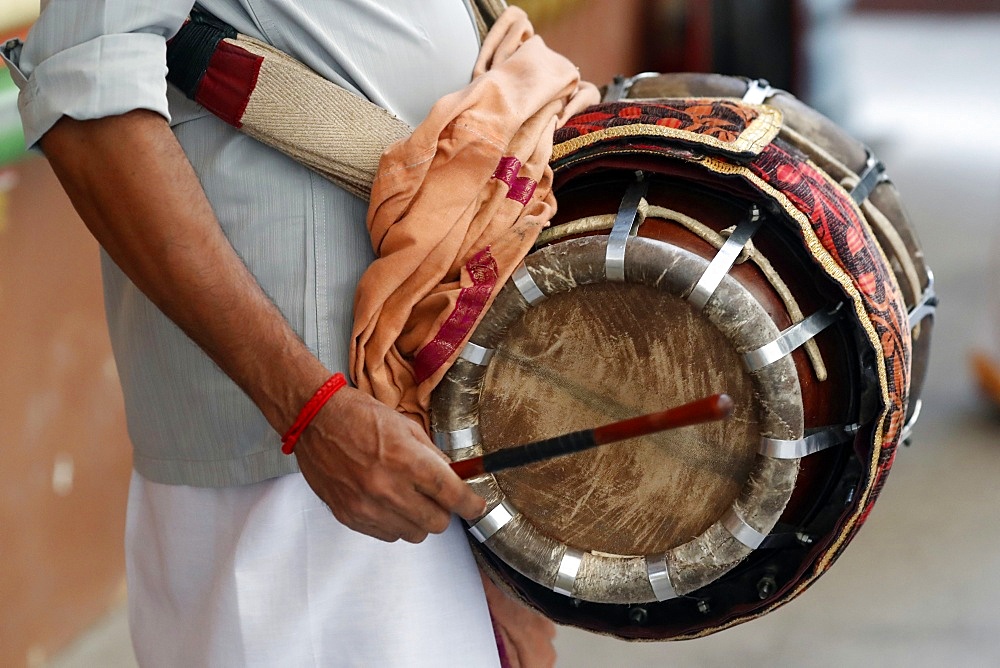 Musician playing a Thavil, a traditional Indian drum, Sri Mahamariamman Hindu Temple, Kuala Lumpur. Malaysia, Southeast Asia, Asia