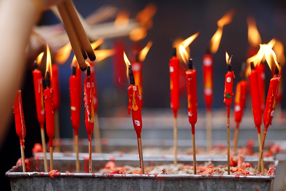 Chinese man burning incense and praying to a prosperous future, Guan Di Chinese Taoist Temple, Kuala Lumpur, Malaysia, Southeast Asia, Asia